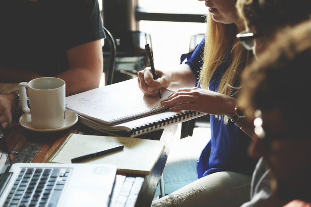 Coffee Cup On Work Desk with People